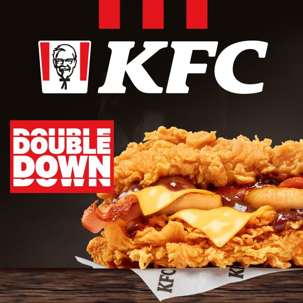 Soczysty Double Down z KFC z dwoma kawałkami kurczaka, serem i bekonem na ciemnym tle.
