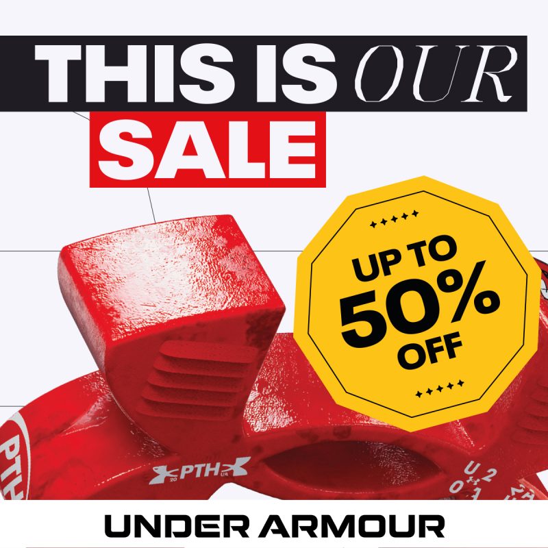 Grafika reklamowa marki Under Armour przedstawia informację o wyprzedaży na jasnym tle z widocznym dużym, czerwonym detalem technicznym obuwia lub sprzętu sportowego. Na plakacie umieszczono napisy w języku angielskim „THIS IS OUR SALE” oraz dużą, żółtą ośmiokątną grafikę z hasłem zniżkowym „UP TO 50% OFF”.