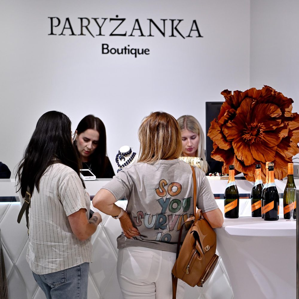 Klientki przy ladzie kasowej w Paryżanka Boutique podczas wydarzenia ze szampanem.